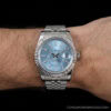 Silver wristwatch with a sky-blue dial